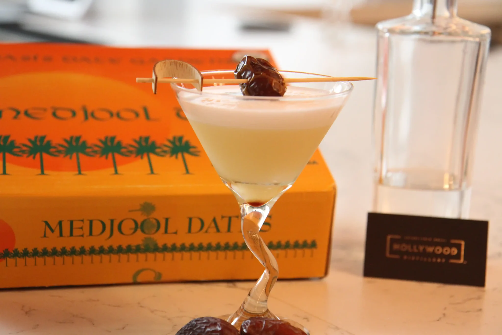 Yellow Cocktail with medjool date as a garnish